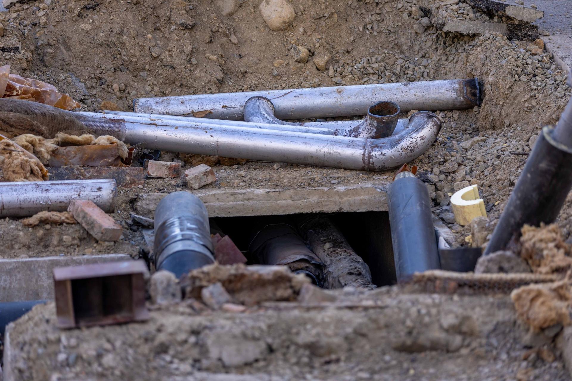 Utility pipe and fittings laid in an open trench before backfill