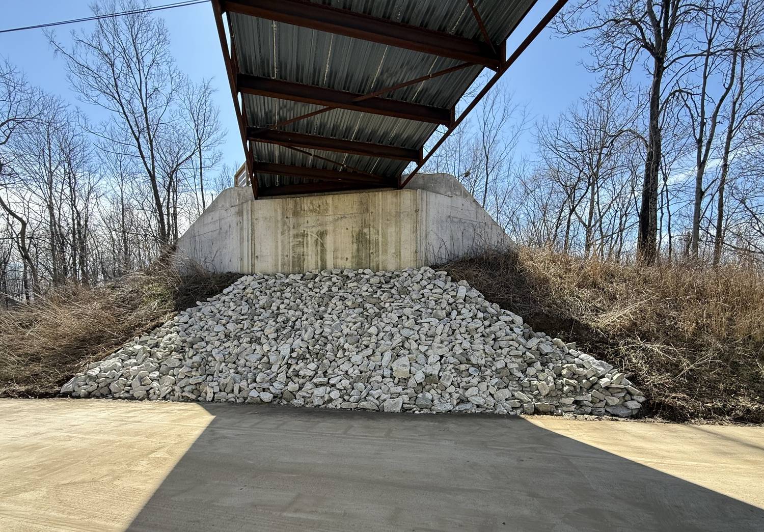 Rip rap stone placed on the slope beneath a bridge abutment